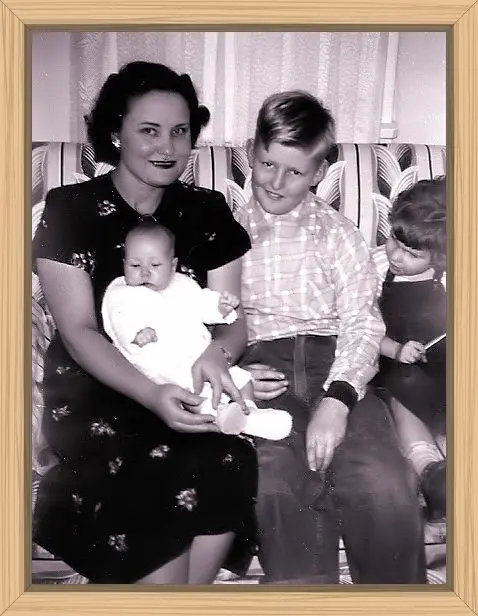 My mom holding me as a baby with Wayne and my cousin Carol looking on.