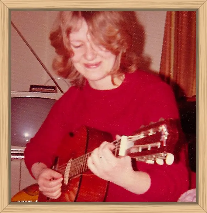 Me playing guitar in my first apartment.