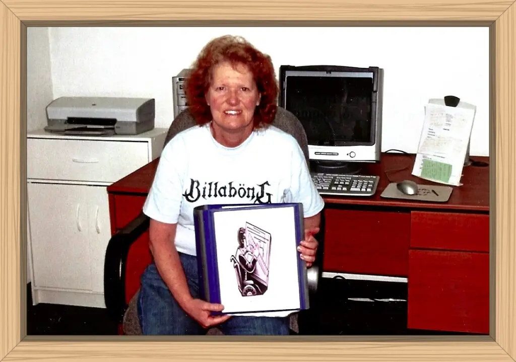 I am holding the first draft of my memoir while working in my office.