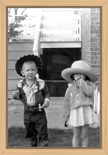 When we were about three, my cousin and I were decked out in our cowboy and cowgirl garb. Dennis has a hammer. I am sucking my thumb and have a pipe in my hand.