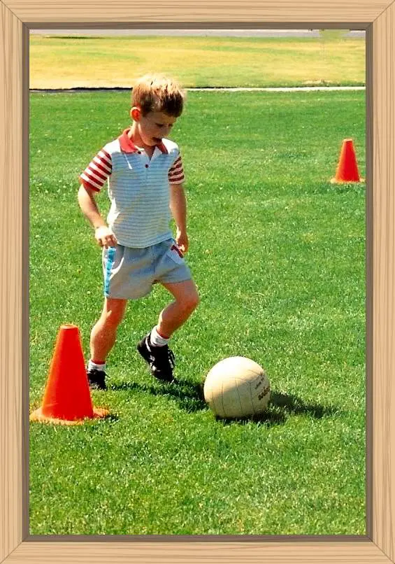This picture of Hayes kicking the soccer ball shows his large calf muscles.