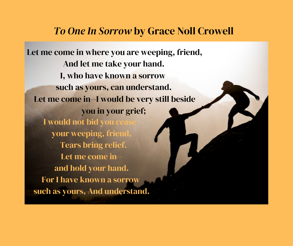 One person has another person's hand in theirs helping them to walk up a steep mountain slope.