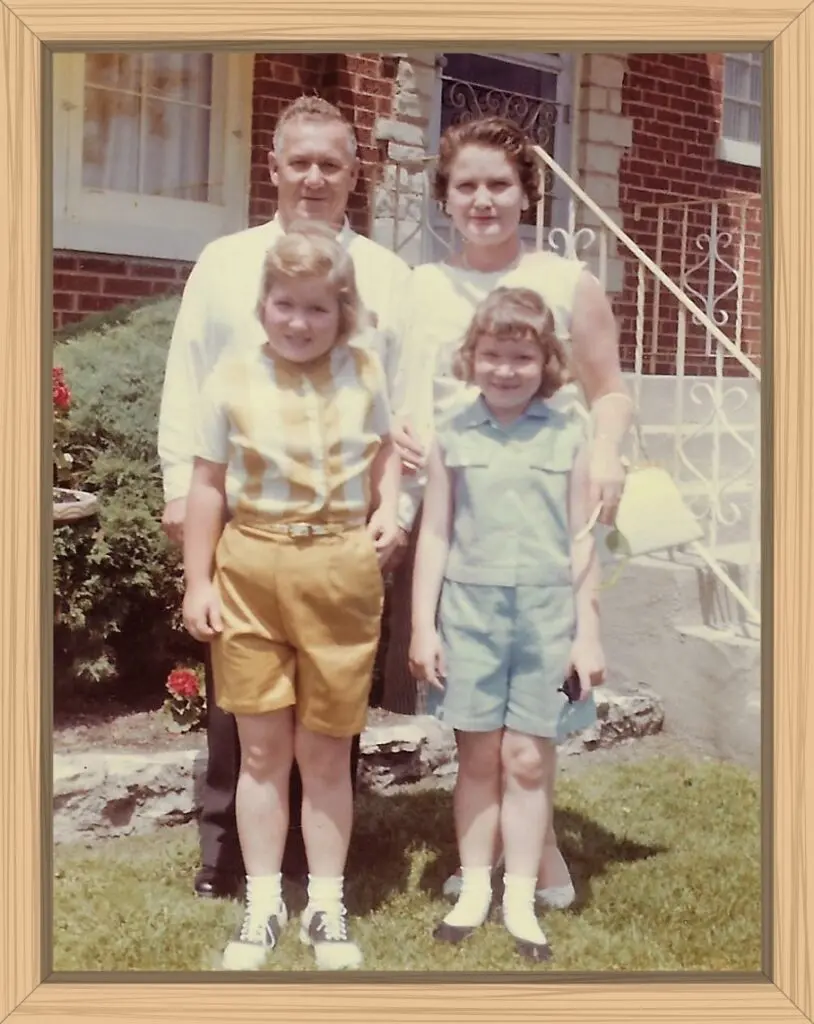 My dad, mom, me, and my sister were standing for a picture in front of our house in Bellwood. I have swooped hairstyle and twisted shorts. Yikes!