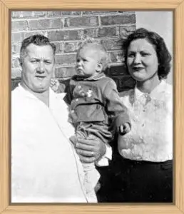 My dad holding me as a toddler and my mom is in the picture too.