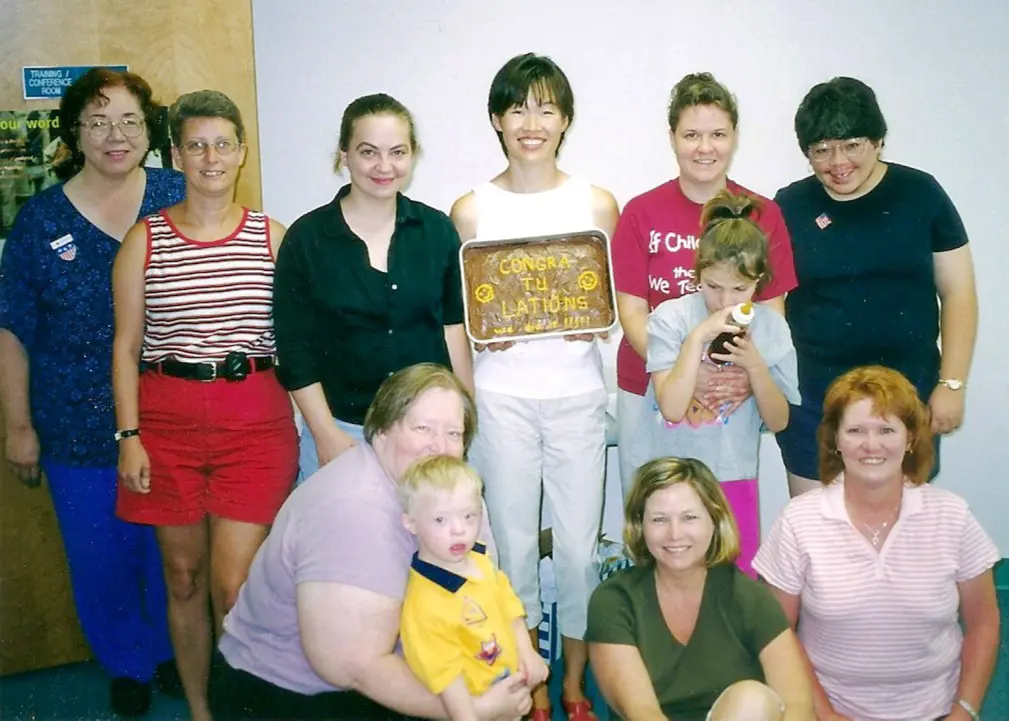 Nine members of the Advisory Council and two moms are holding their children.