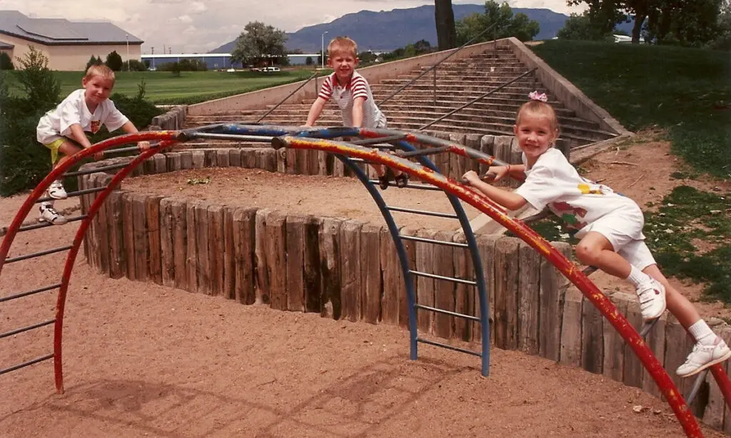 Hayes and his cousins Keith and Aubre are climbing on a metal ladder structure in Old Town, New Mexico. He could still climb when he was four and a half years old.