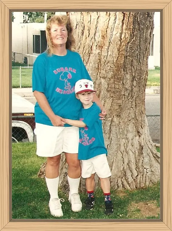 Hayes is giving me a big hug in front of our huge cottonwood tree, where we posed for many pictures over the years. He is wearing a Chicago Bulls baseball cap, and we are wearing our matching Eubank Beagles T-shirts.
