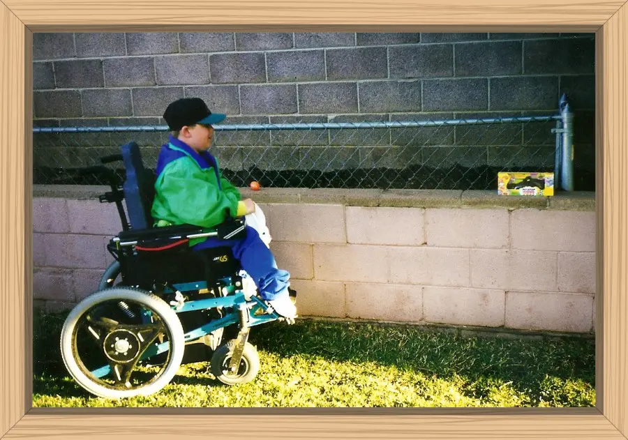 Hayes in his power wheelchair going for a boxed chocolate buddy and collecting the plastic eggs filled with treats.