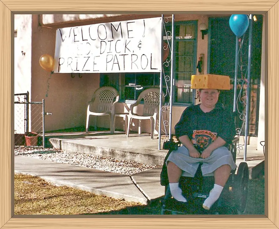 Hayes with a Green Bay cheese hat and Chicago Bears shirt on waiting for the big check to arrive.