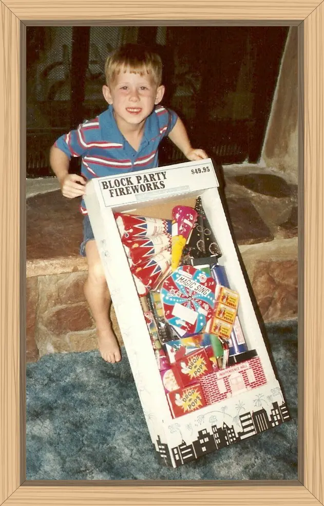 Hayes holding the $49.95 big box of Block Party Fireworks to be lit as soon as it gets dark.