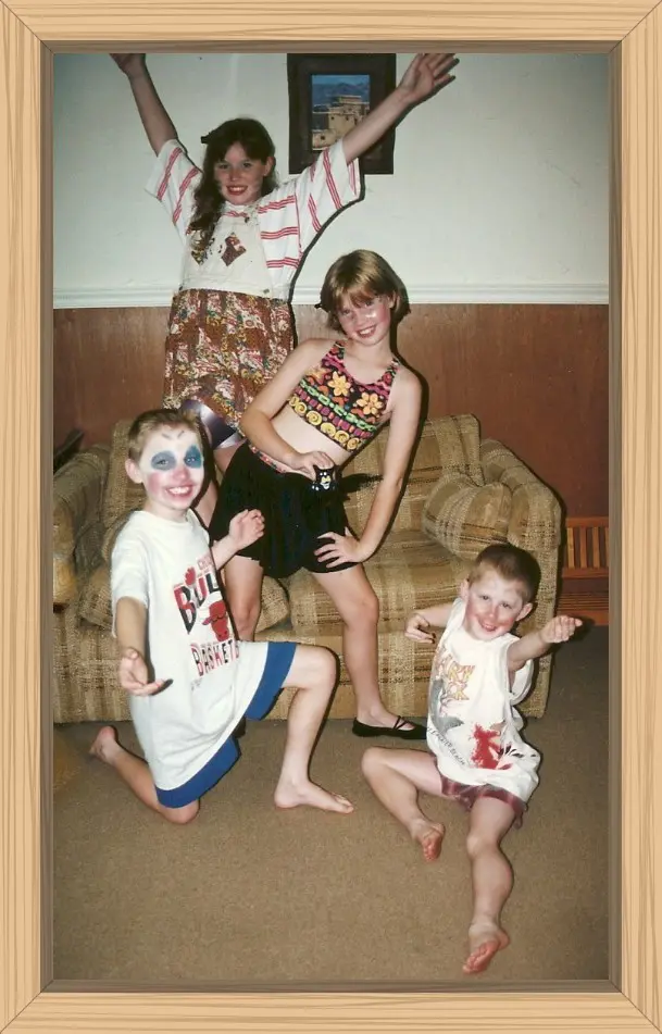 The four cousins posing for the play they are about to put on for the adults. They even have on their theatrical makeup.