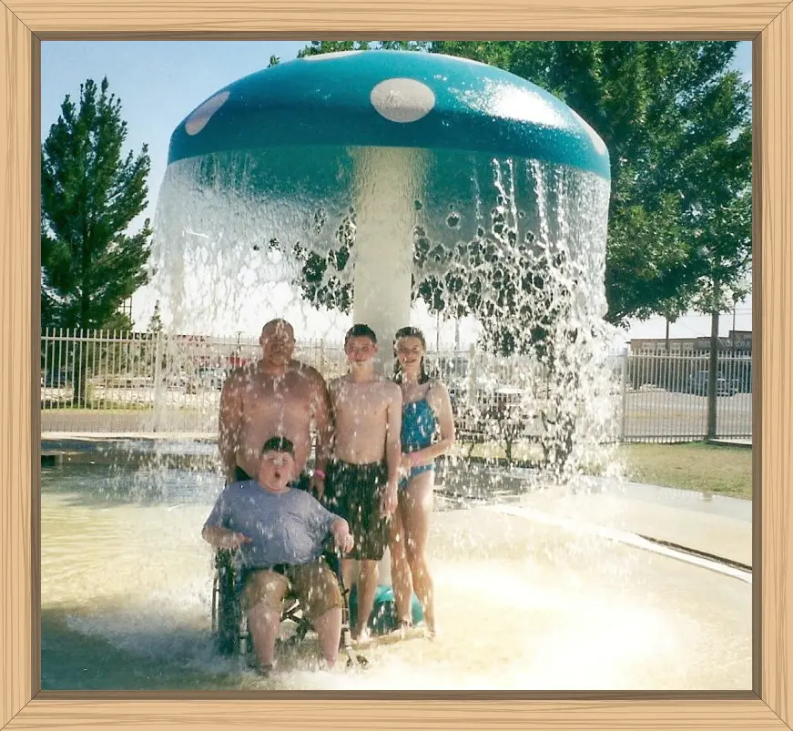 Giant mushroom waterfall with Hayes in his manual wheelchair, Pete, and my sister's twins getting soaked underneath.