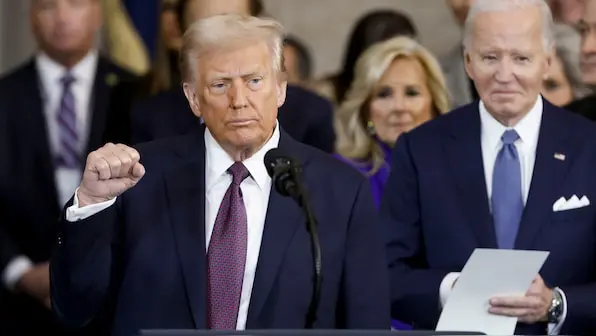 Trump next to Biden during the 2025 Inauguration with Jill Biden behind him.