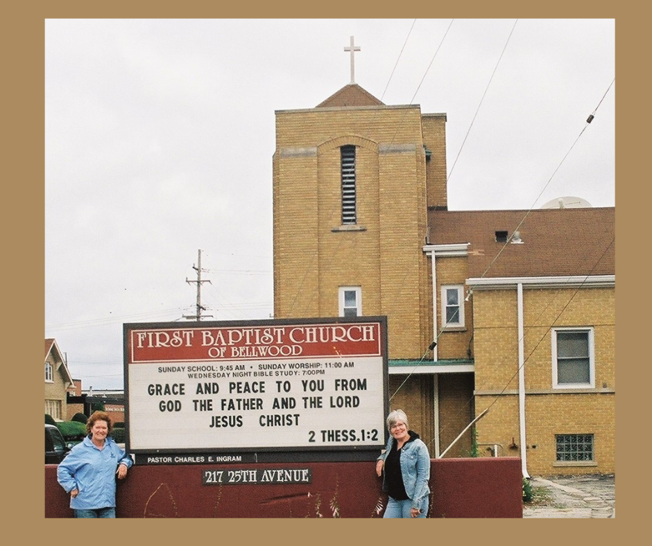 My sister and I are standing in front of the First Baptist Church of Bellwood sign. The sign reads "Grace and peace to you from God the Father and the Lord Jesus Christ."